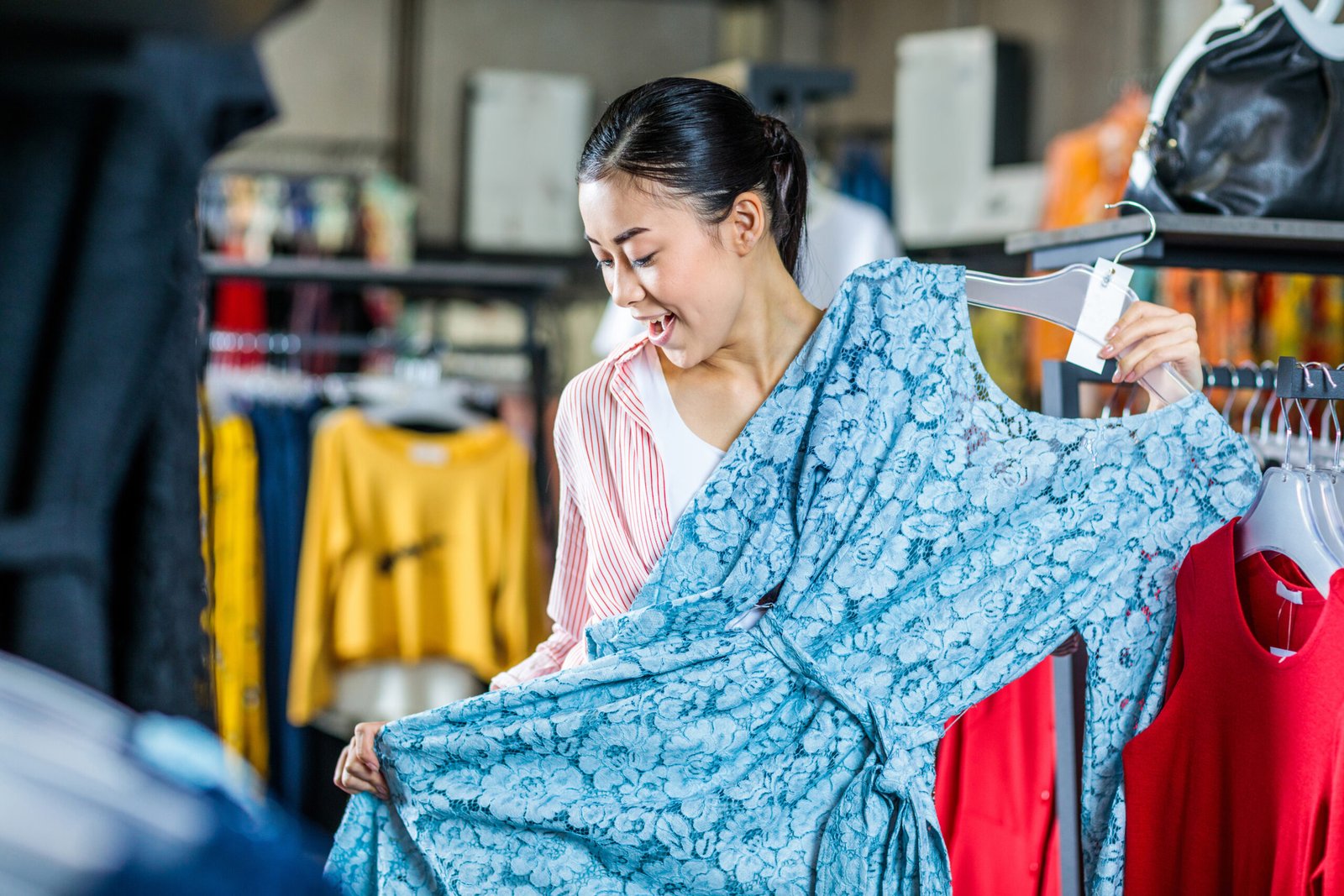 asian hipster girl choosing clothes in shopping mall, boutique shopping concept