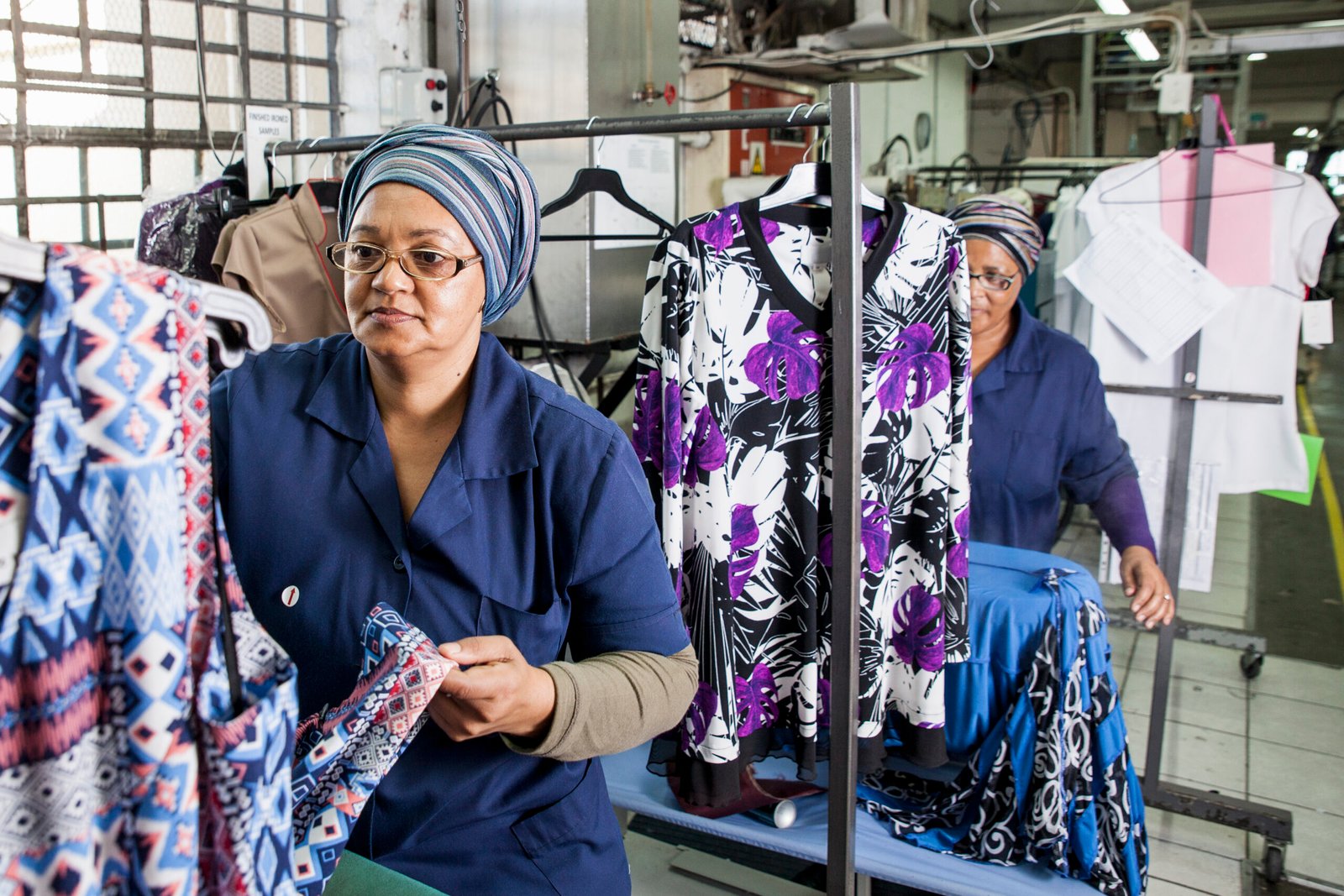 Workers examining dress in garment factory